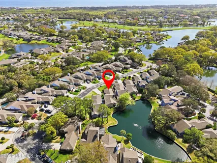 an aerial view of residential houses with outdoor space