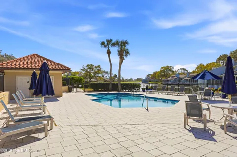a view of a swimming pool with outdoor seating