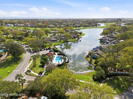 an aerial view of lake residential house with outdoor space and trees