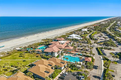 an aerial view of a house with a swimming pool yard and outdoor seating