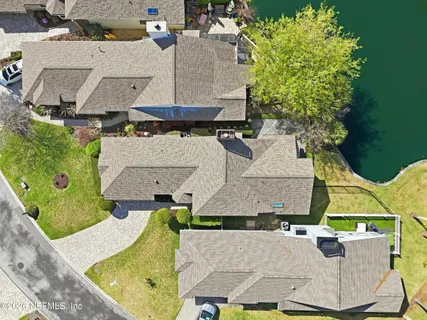 an aerial view of a house with swimming pool and outdoor seating