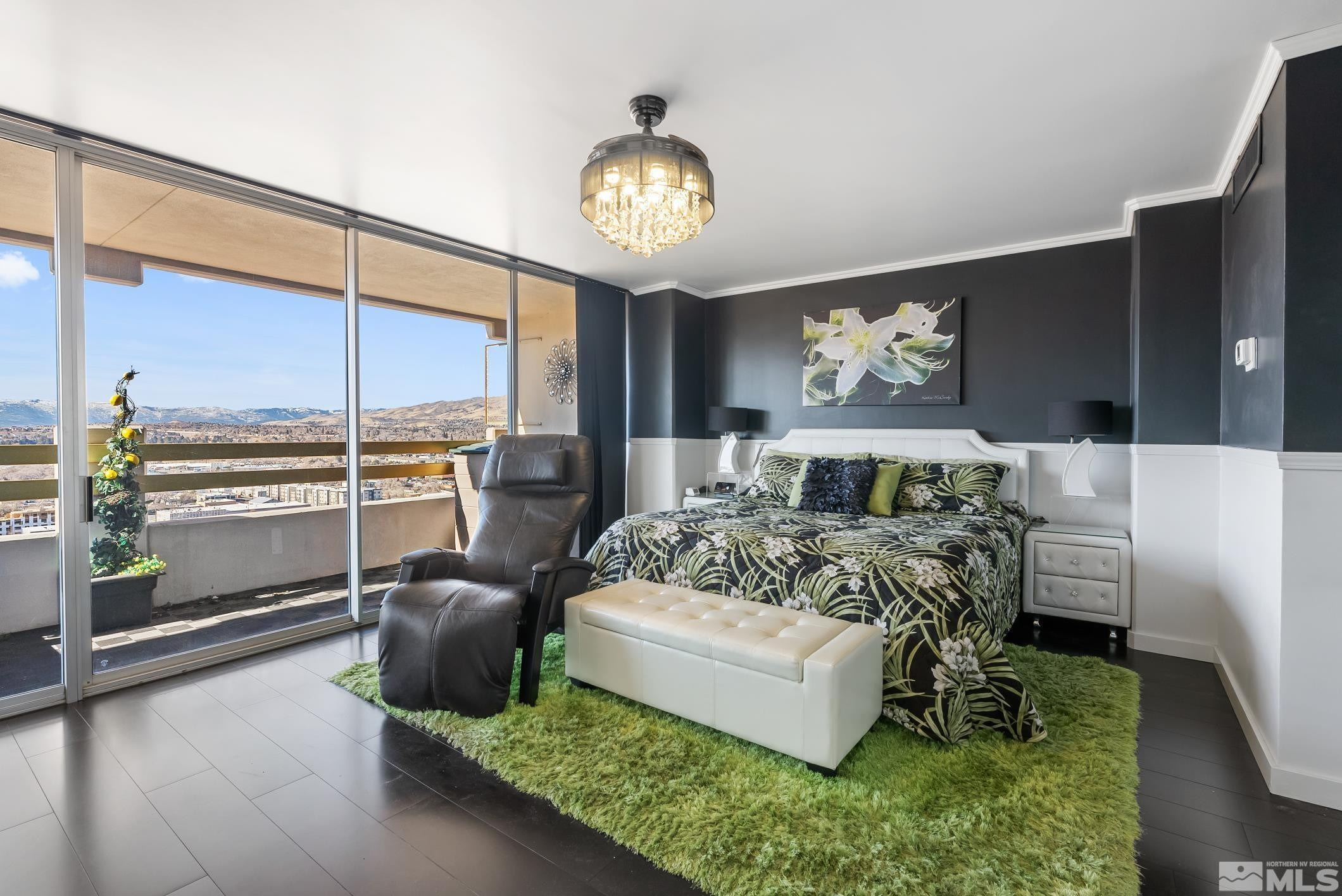 100 North Arlington Avenue, Unit 23N Reno, NV 89501 - Photo 6 of 17 a spacious bedroom with a bed and a chandelier