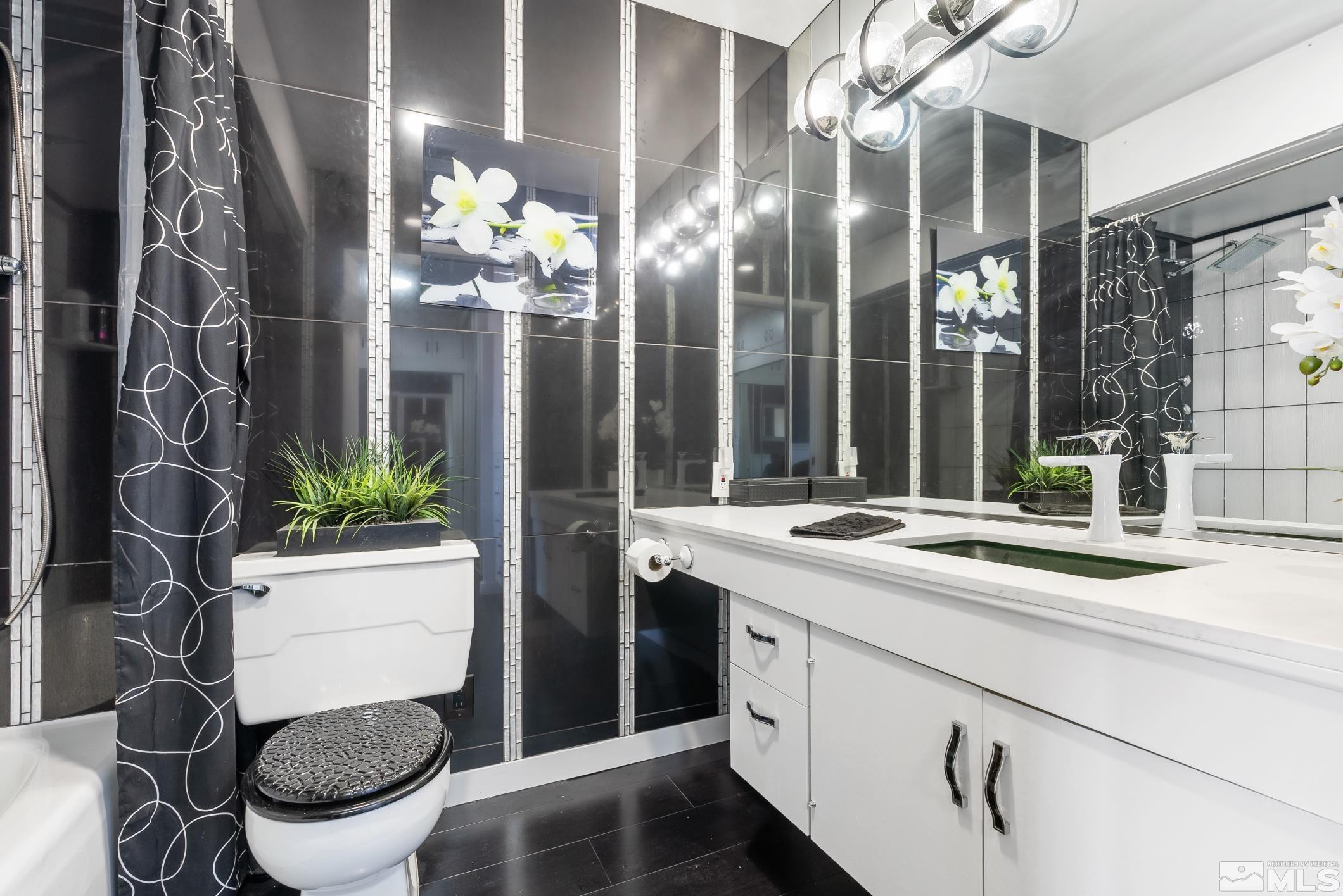 100 North Arlington Avenue, Unit 23N Reno, NV 89501 - Photo 9 of 17 a bathroom with a sink and mirror with toilet