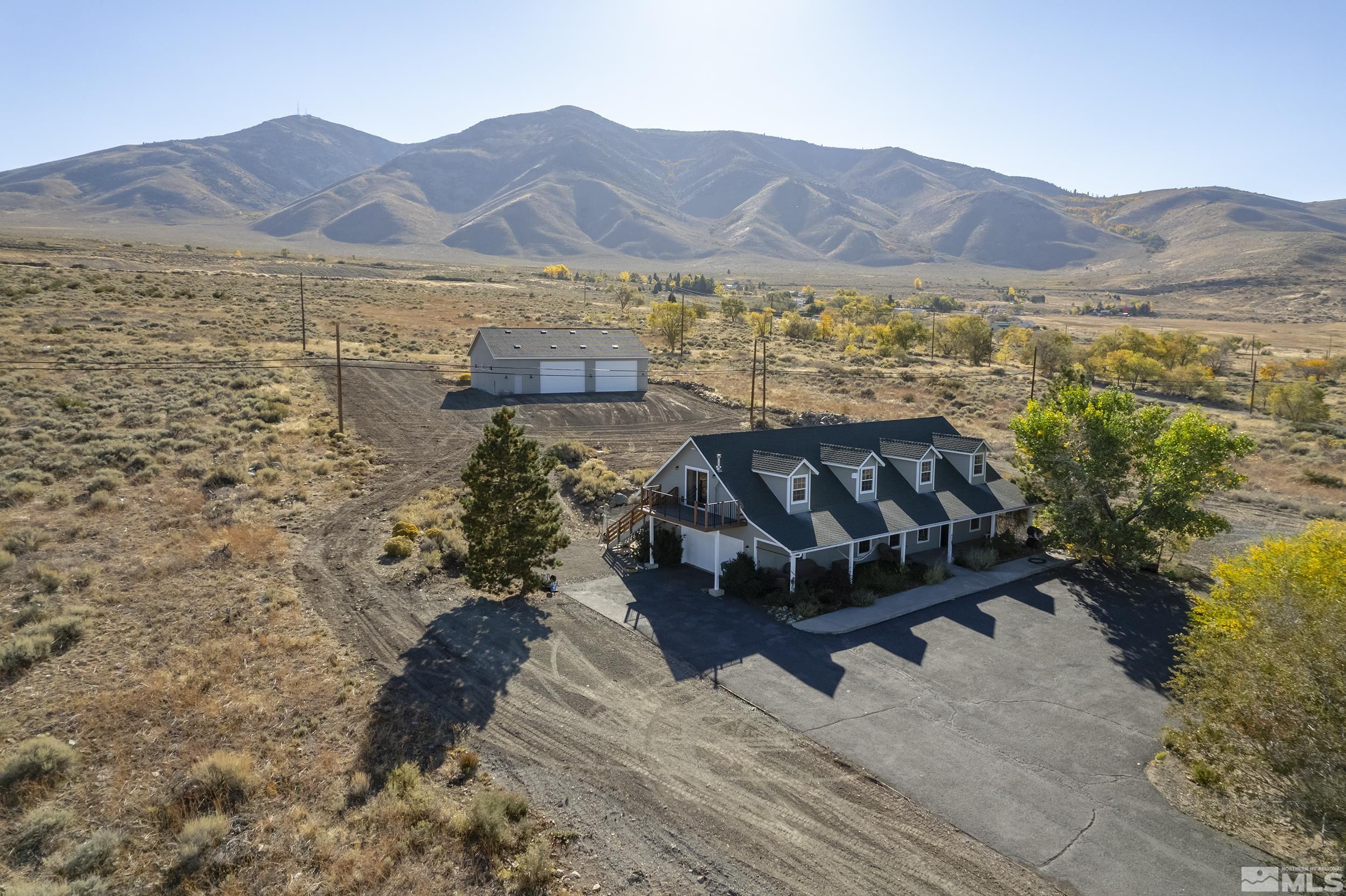 a view of a house with a mountain yard