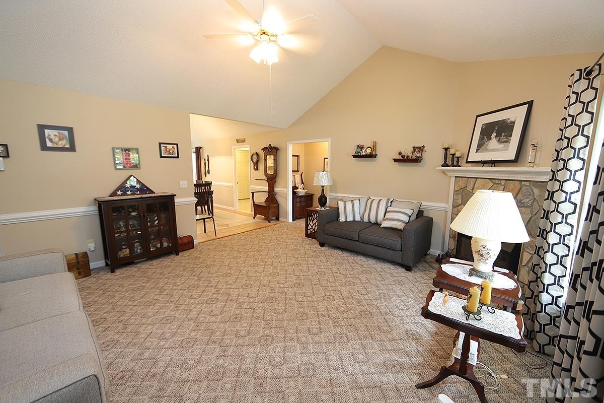 112 Dullis Circle Garner, NC 27529 - Photo 5 of 23 a living room with furniture a rug and a chandelier