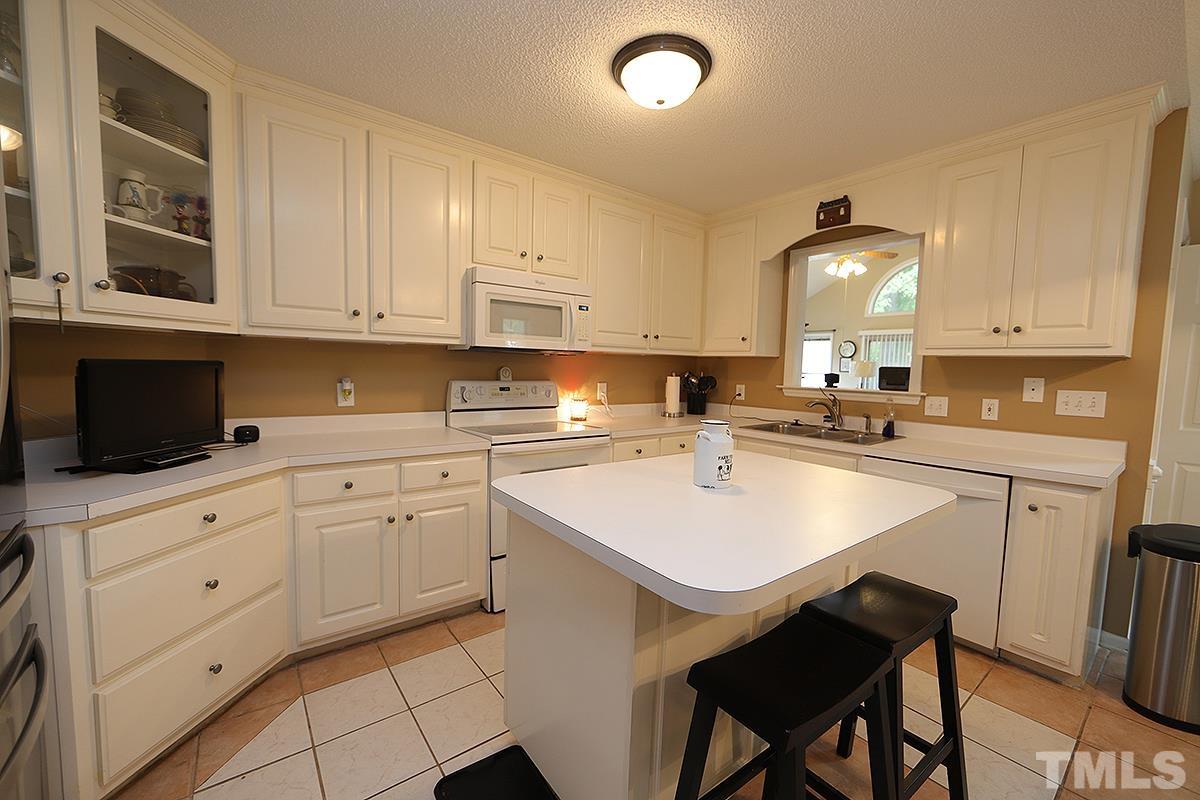 112 Dullis Circle Garner, NC 27529 - Photo 8 of 23 a kitchen with a sink cabinets and window
