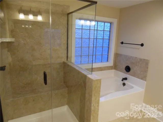 a bathroom with a bathtub and shower