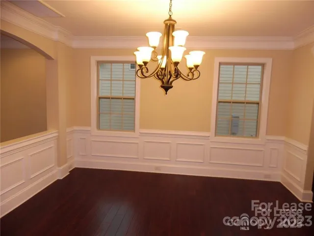 a bathroom with a window and a chandelier