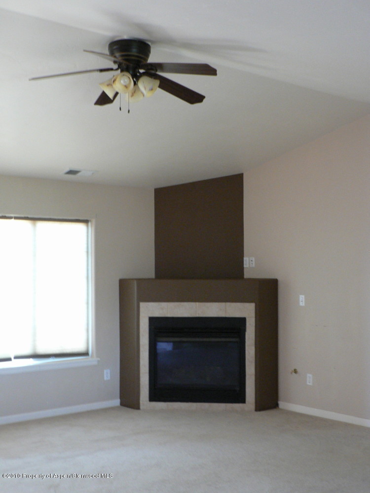 779 West 26th Street Rifle, CO 81650 - Photo 7 of 26 living room shows fp and fan light