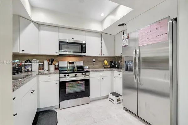 a kitchen with a refrigerator stove and sink