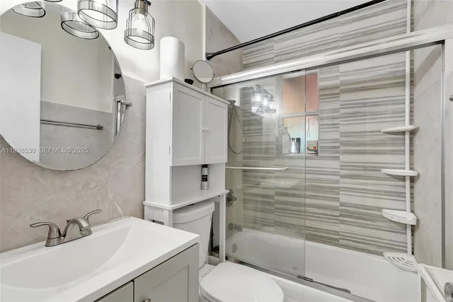 a bathroom with a sink toilet and shower