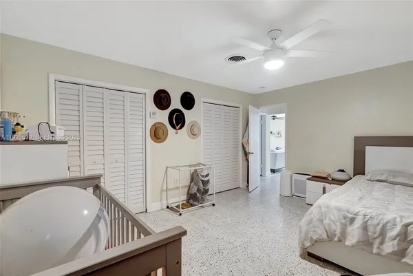 a living room with furniture and view of bathroom