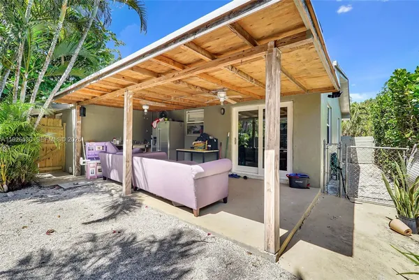 a view of a patio with a table and chairs under an umbrella
