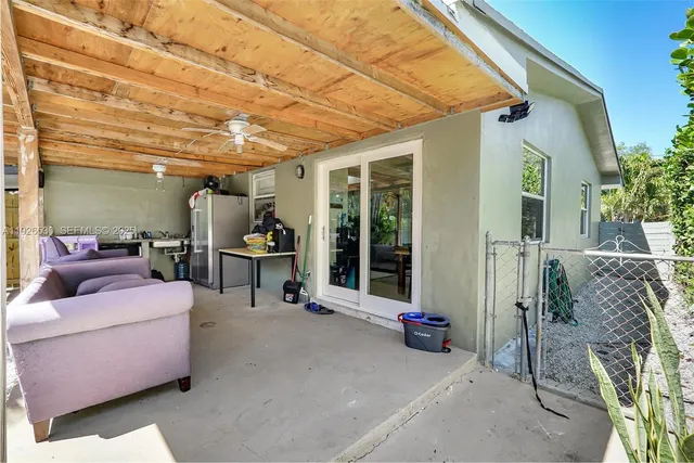 a view of a patio with a table and chairs and potted plants