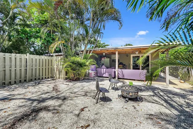 a view of a chairs and table in backyard