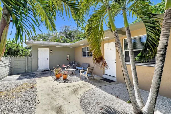 a view of a house with backyard and sitting area
