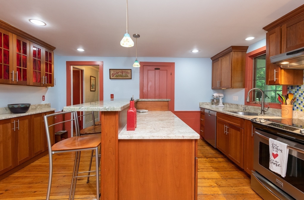 304 North Street Georgetown, MA 01833 - Photo 11 of 42 a kitchen with stainless steel appliances granite countertop sink stove top oven and cabinets