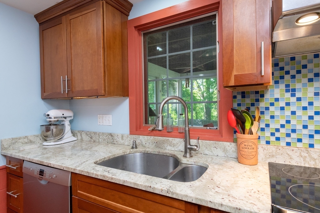 304 North Street Georgetown, MA 01833 - Photo 12 of 42 a kitchen with granite countertop a sink and a window
