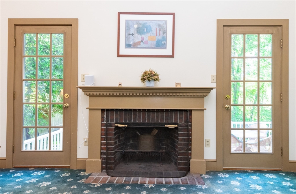 304 North Street Georgetown, MA 01833 - Photo 22 of 42 a living room with a fireplace and windows