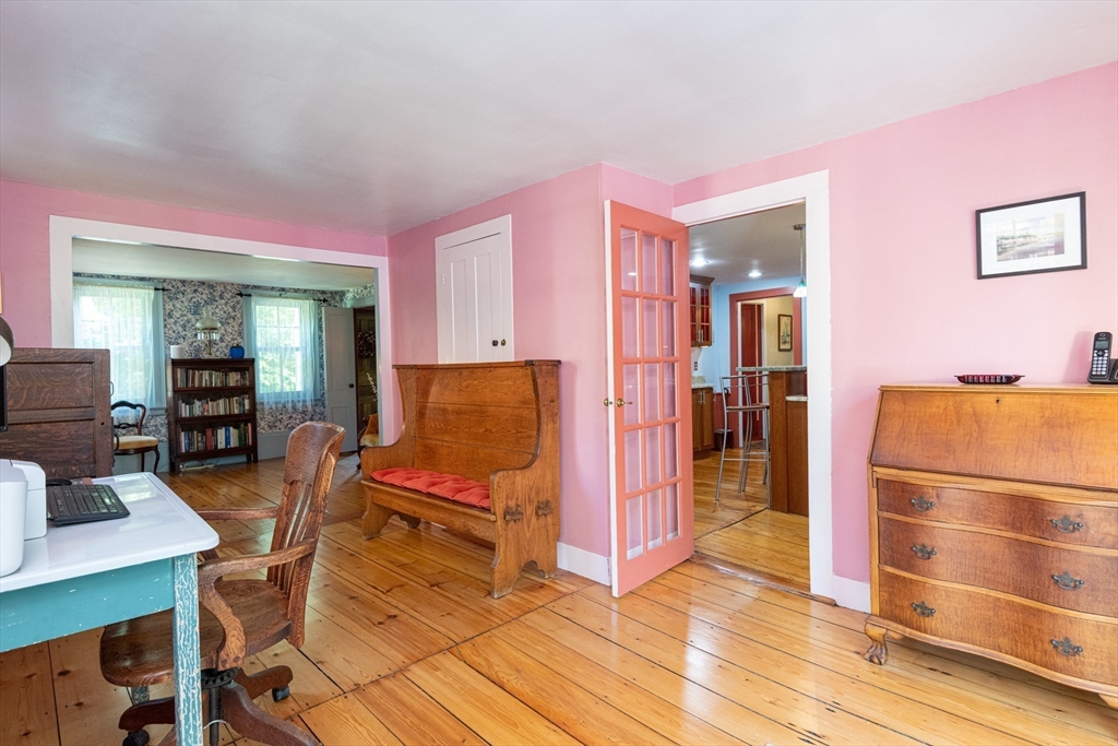 304 North Street Georgetown, MA 01833 - Photo 27 of 42 a living room with furniture a dining table and chairs with wooden floor