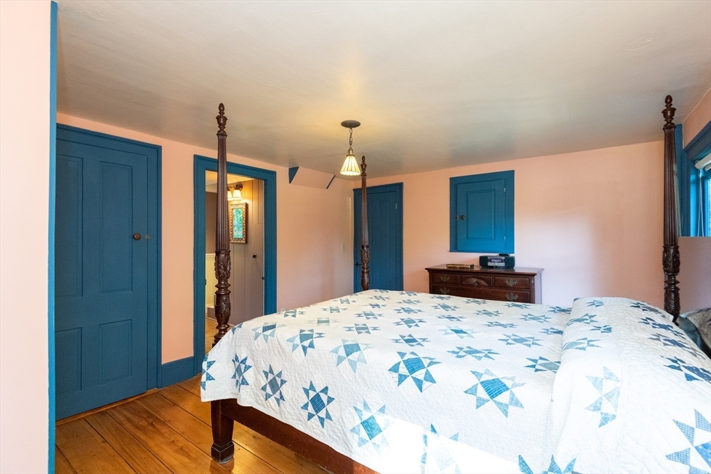 304 North Street Georgetown, MA 01833 - Photo 28 of 42 a bed room with a bed mirror and a night stand