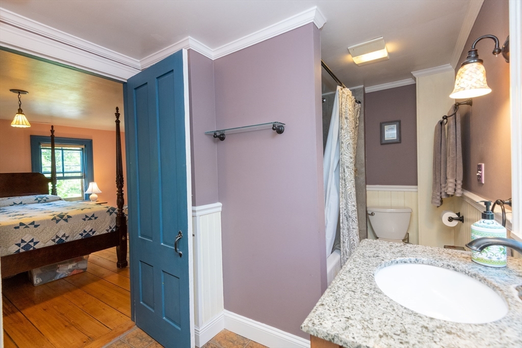 304 North Street Georgetown, MA 01833 - Photo 30 of 42 a en suite bathroom with a granite countertop sink and a mirror