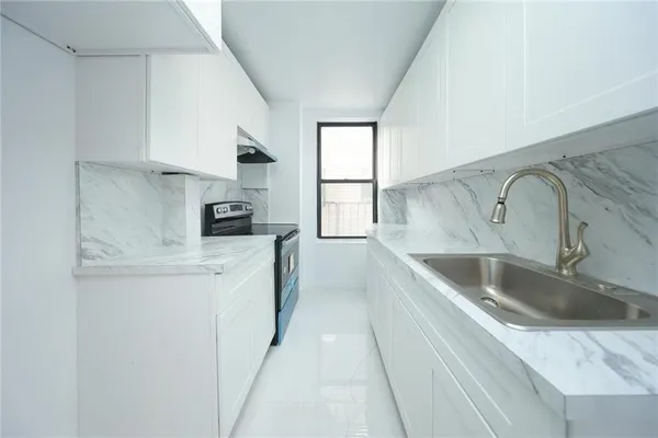 a kitchen with stainless steel appliances granite countertop a sink and a stove