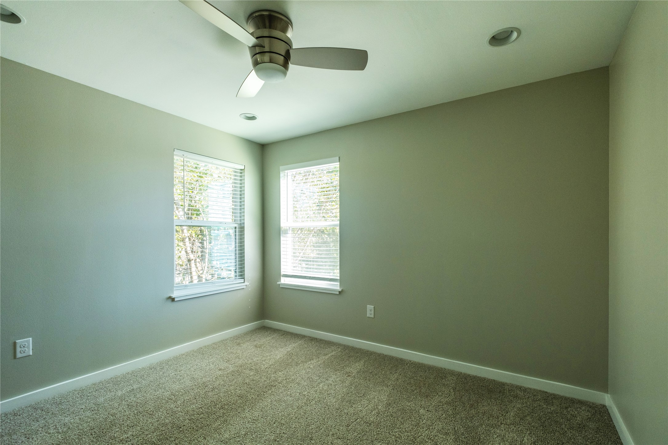 7601 Bethune Avenue, Unit B Austin, TX 78752 - Photo 20 of 39 an empty room with windows and ceiling fan
