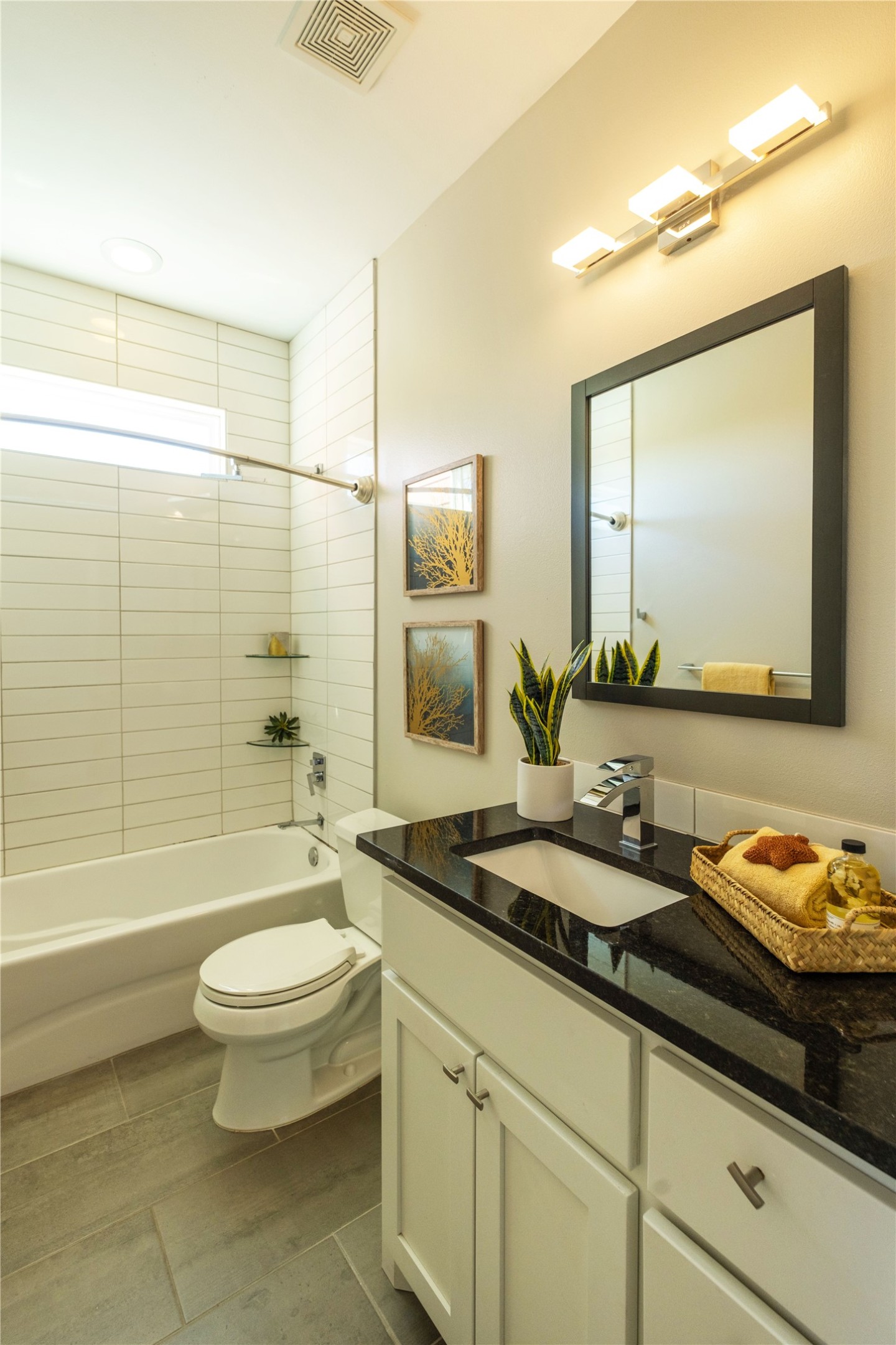 7601 Bethune Avenue, Unit B Austin, TX 78752 - Photo 24 of 39 a bathroom with a granite countertop sink toilet a mirror and bathtub