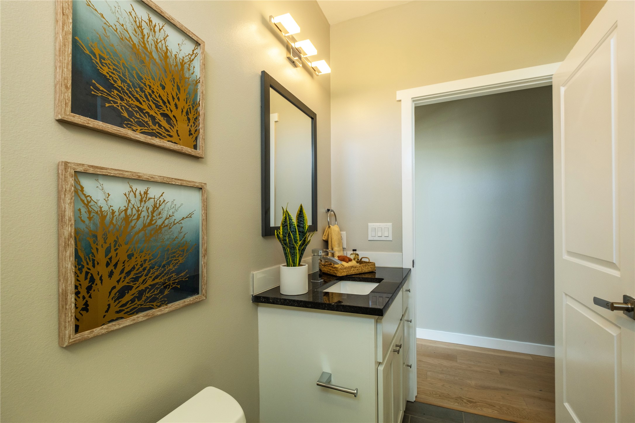 7601 Bethune Avenue, Unit B Austin, TX 78752 - Photo 26 of 39 a bathroom with a sink a mirror and painting on the wall