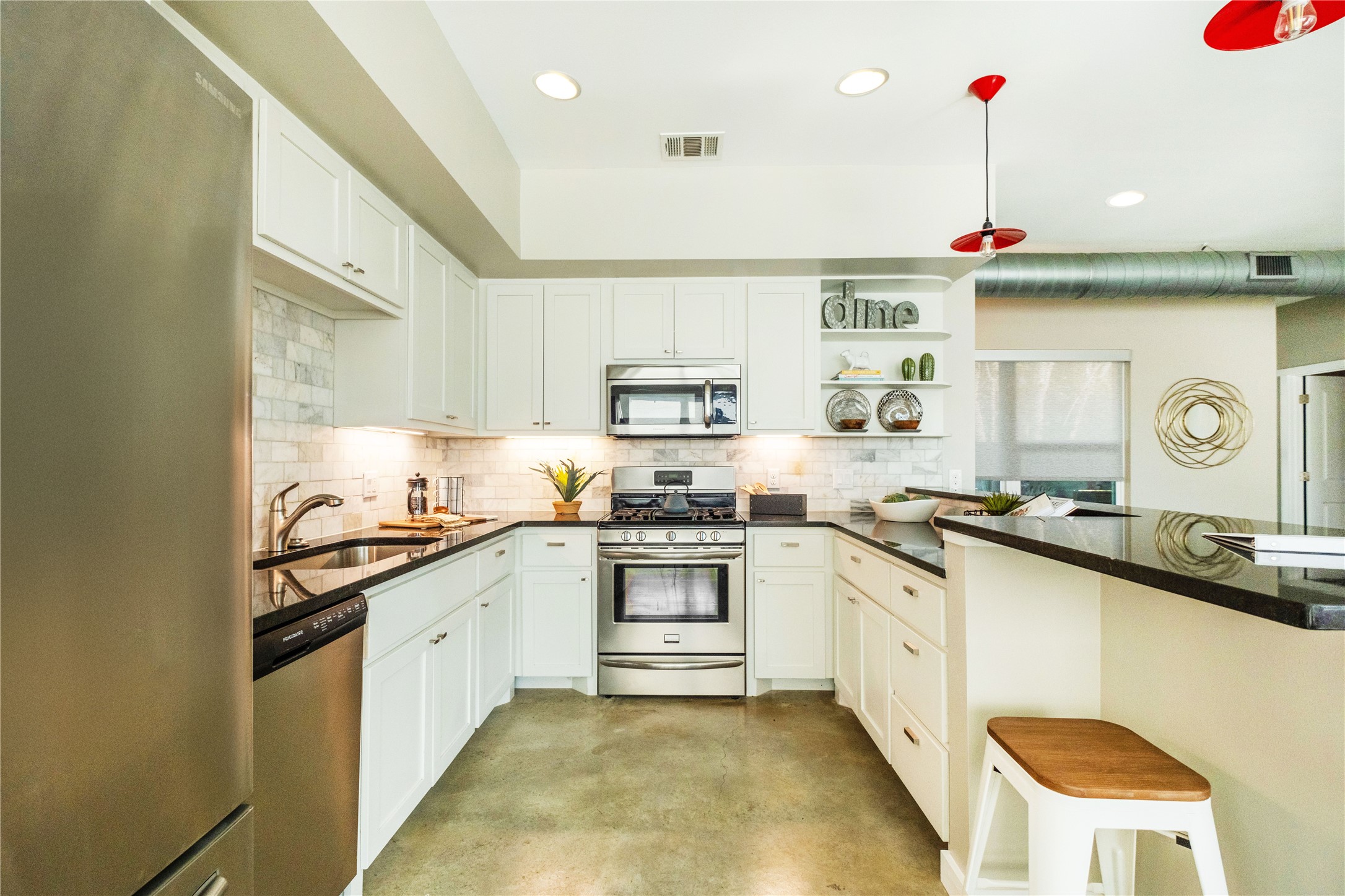 7601 Bethune Avenue, Unit B Austin, TX 78752 - Photo 5 of 39 a kitchen with stainless steel appliances granite countertop a sink and cabinets