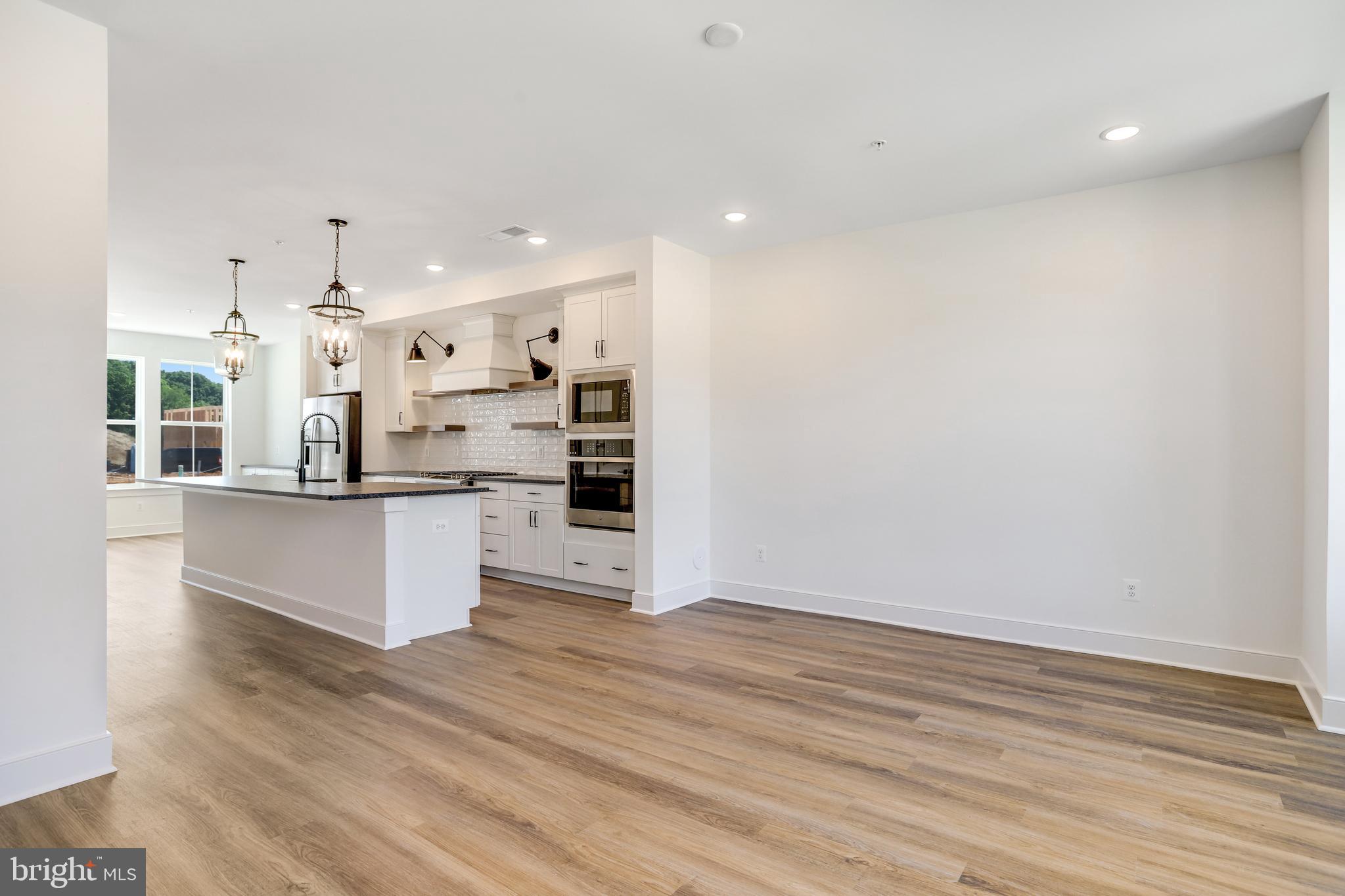 751 Elevation Road Frederick, MD 21702 - Photo 15 of 35 a large kitchen with stainless steel appliances a large counter top a stove and a refrigerator