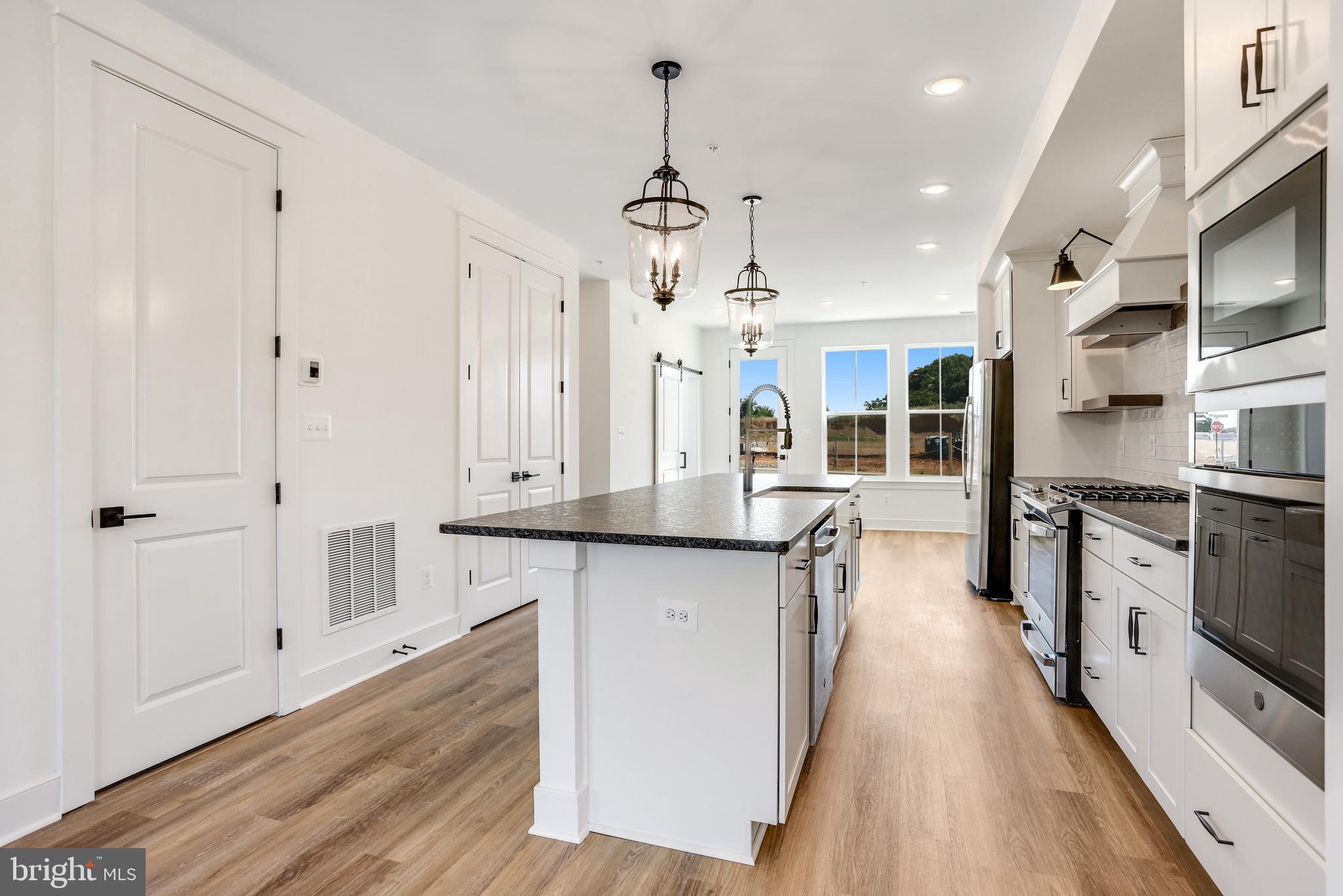 751 Elevation Road Frederick, MD 21702 - Photo 7 of 35 a kitchen with stainless steel appliances a stove refrigerator and cabinets