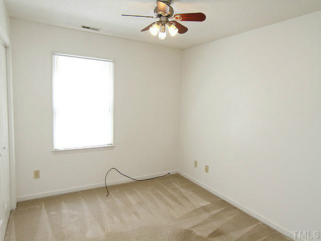 5304 Middleton Road Durham, NC 27713 - Photo 12 of 16 an empty room with a window and a fan