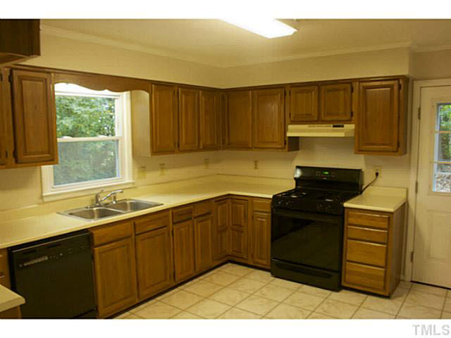 5304 Middleton Road Durham, NC 27713 - Photo 7 of 16 a kitchen with a sink and wooden cabinets