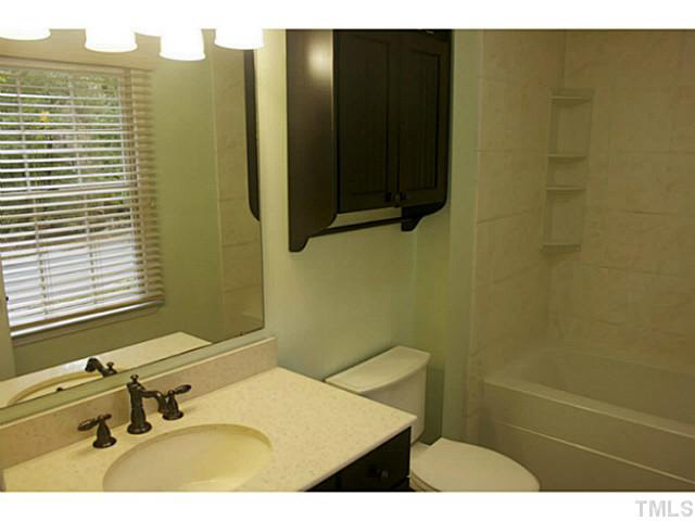 5304 Middleton Road Durham, NC 27713 - Photo 9 of 16 a bathroom with a sink and a mirror