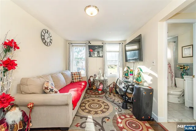 a living room with furniture and flowers