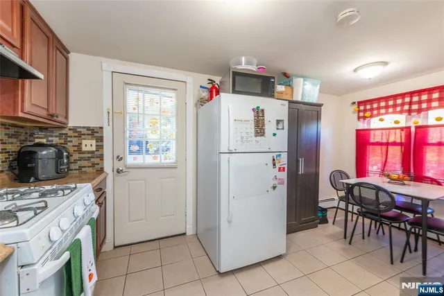 a white refrigerator freezer sitting inside of a kitchen