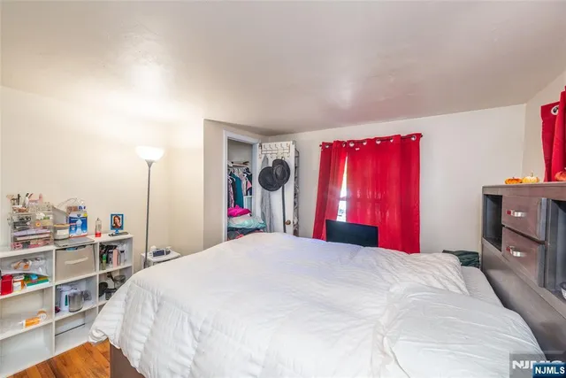 a bedroom with a large bed and a closet