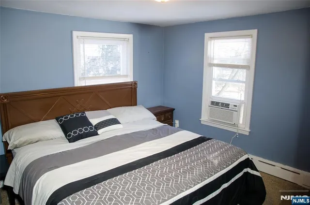 a bedroom with a bed window and window