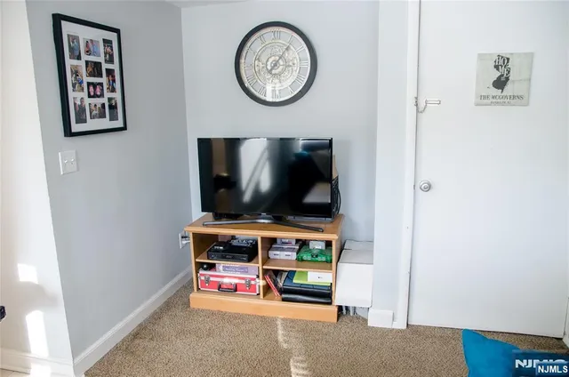 a room with painting on the wall and a flat screen tv