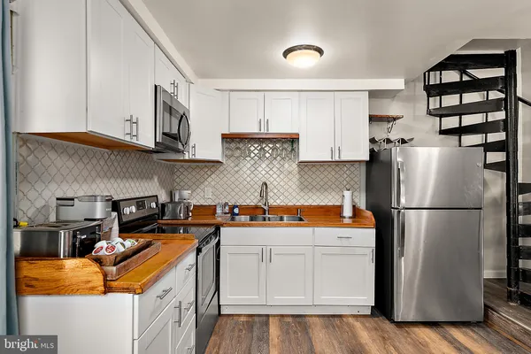 a kitchen with stainless steel appliances granite countertop a refrigerator sink and cabinets