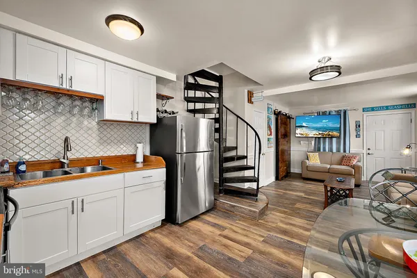 a kitchen with stainless steel appliances a refrigerator and cabinets
