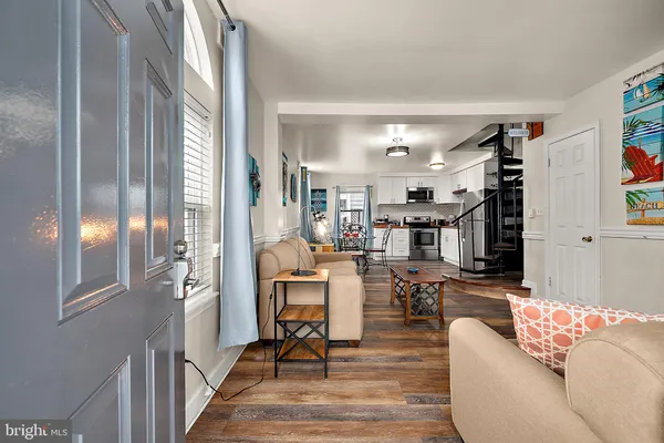 a living room with furniture and a chandelier