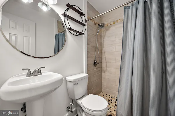 a white toilet sitting next to a bathroom sink