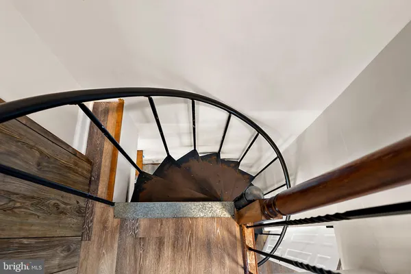 a view of staircase with a metal railing and a large window