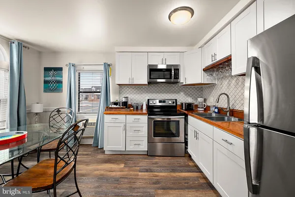 a kitchen with stainless steel appliances a refrigerator stove microwave and sink