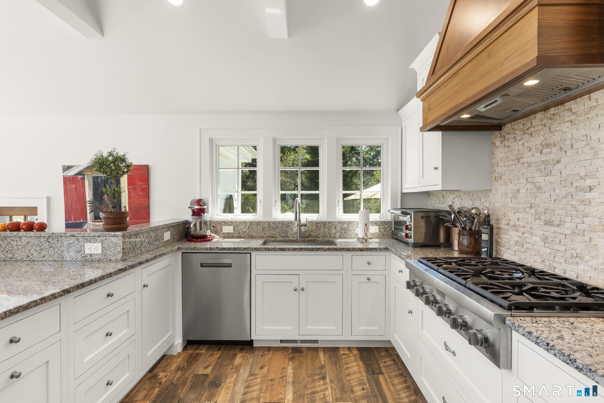 394 Wakeman Road Fairfield, CT 06824 - Photo 13 of 40 Top-of-the-line appliances include a Thermador cooktop, a Viking refrigerator, and double wall ovens.