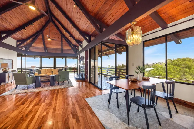 a dining room with furniture and wooden floor