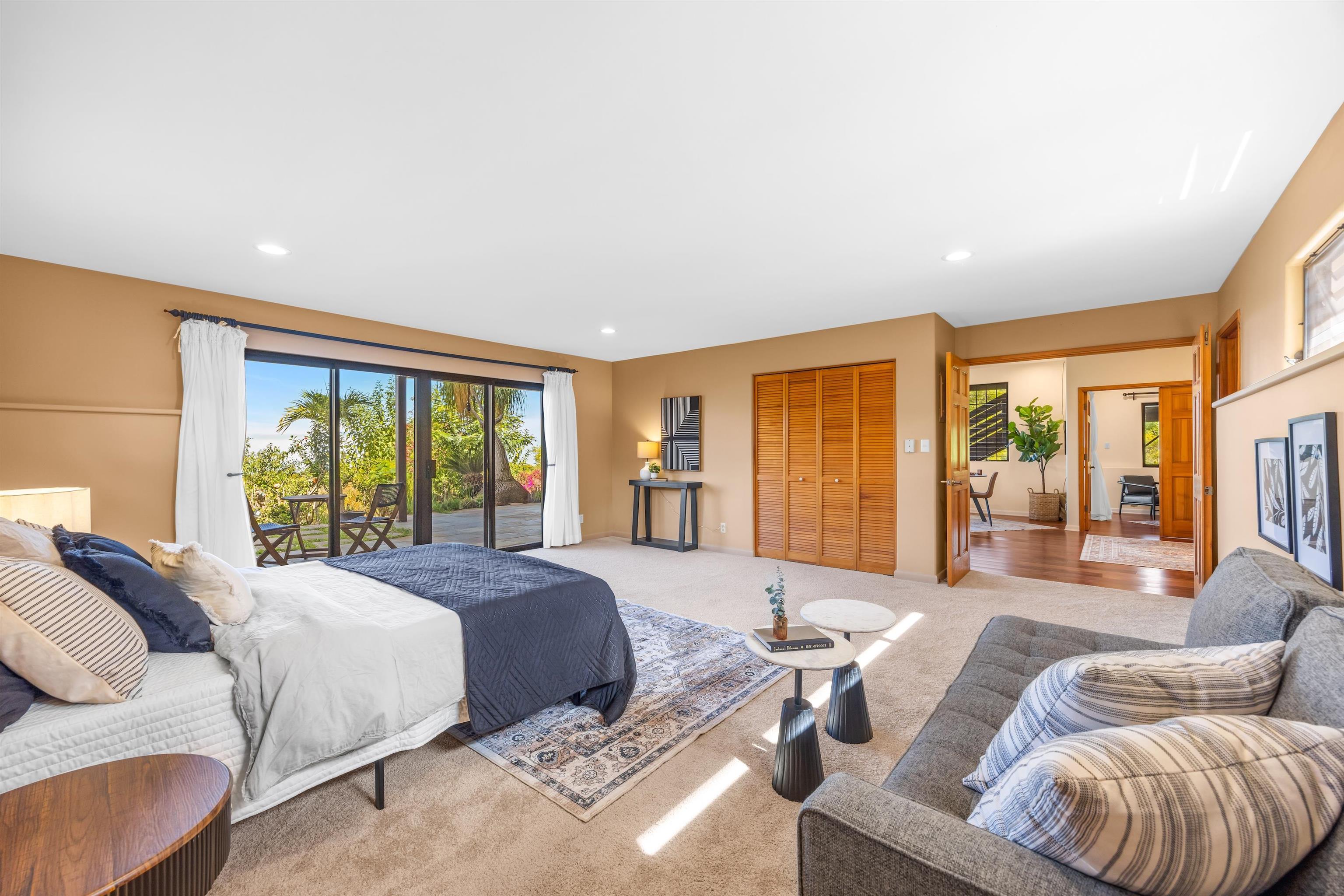 110 Kamehameiki Road Kula, HI 96790 - Photo 15 of 50 a spacious bedroom with a bed a couch and a large window